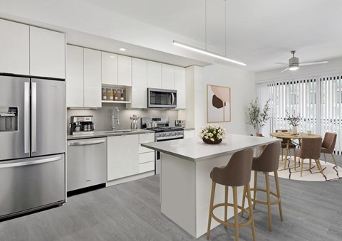 a kitchen with white cabinetry and stainless steel appliances  at SLX Atlanta, Chamblee, Georgia